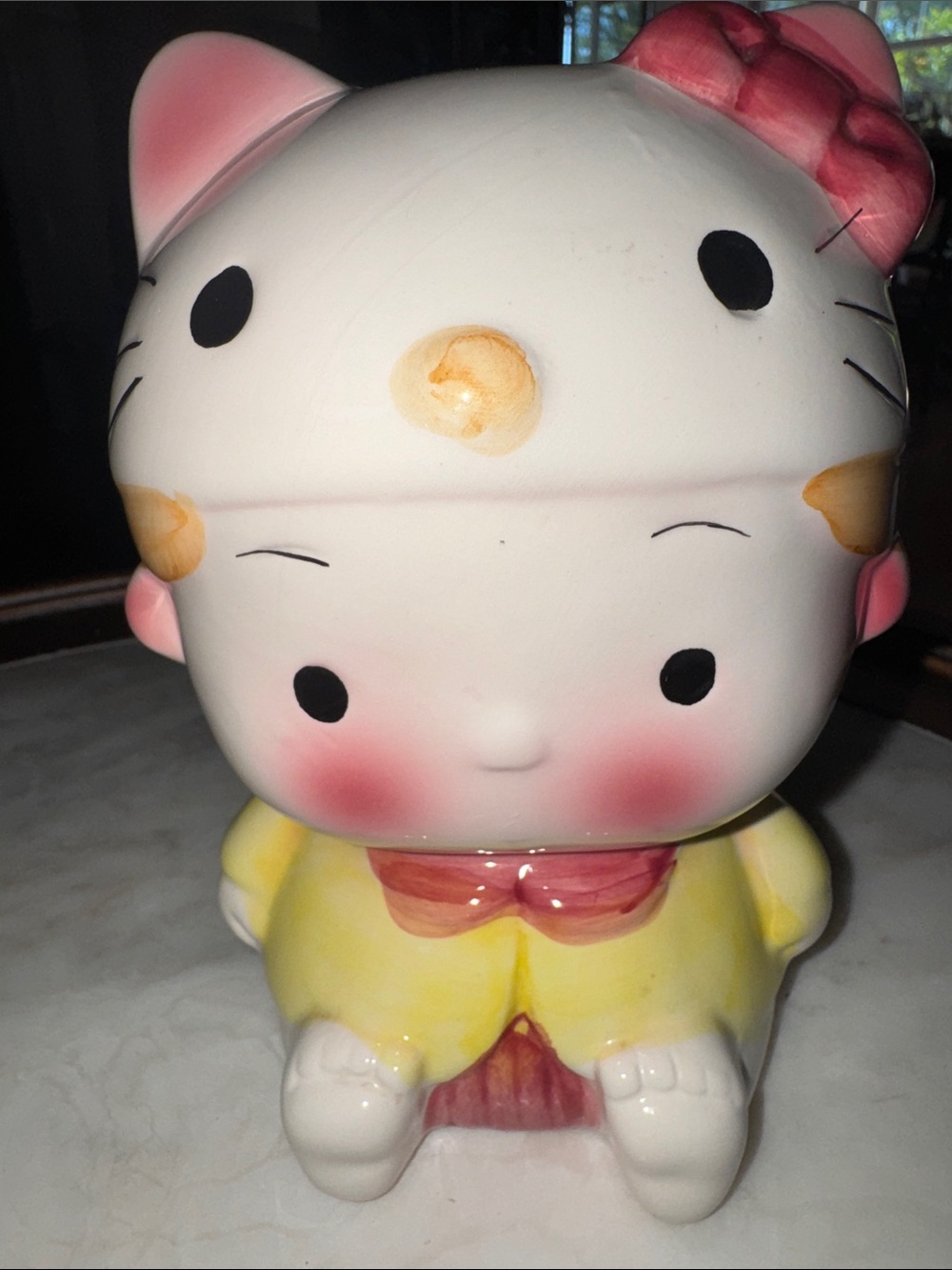 Collectible Ceramic Child wearing Hello Kitty Figurine Bank with Pink Bow